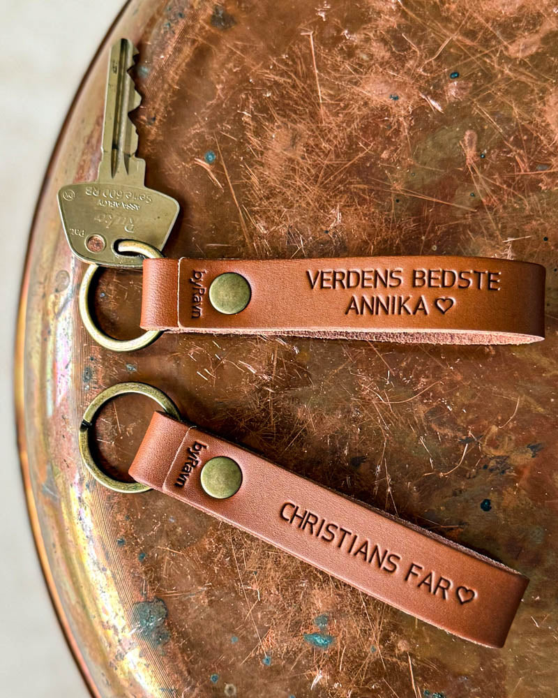 Två BOND nyckelringar i cognac läder med "Verdens bedste Annika" ♡ och "Christians far" ♡ graverat, på kopparbricka med nyckel